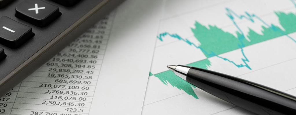 Calculator and pen on financial spreadsheet